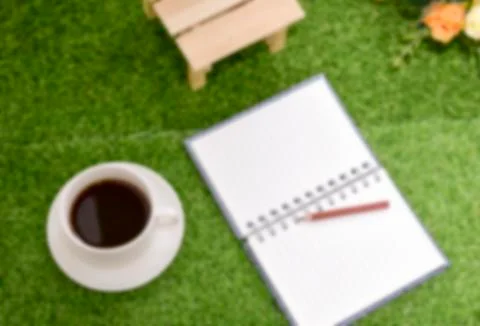 Writing on copy space note book on green grass Background.With selective focu Stock Photos