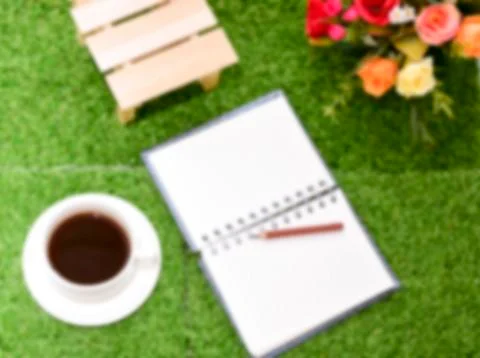 Writing on copy space note book on green grass Background.With selective focu Stock Photos