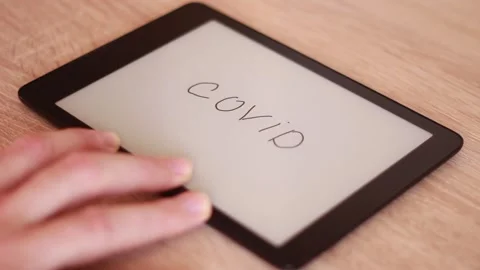 Writing COVID on Electronic tablet 動画素材 166209992