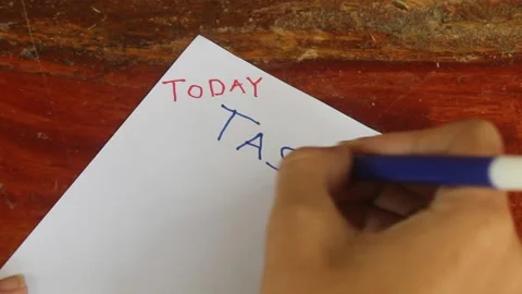 Writing Daily Task List on Paper Stockbeeldmateriaal 345712427