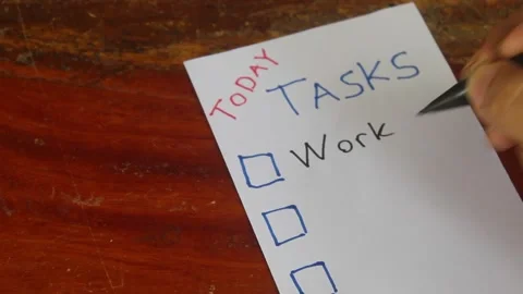 Writing Daily Task List on Paper Stockbeeldmateriaal 345712438