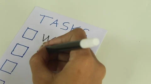 Writing Daily Task List on Paper Stockbeeldmateriaal 345712439