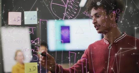 Writing developer in red jacket on glass board with sticky notes in meeting 스톡 사진