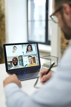 Writing down the best ideas during the online meeting Stock Photos