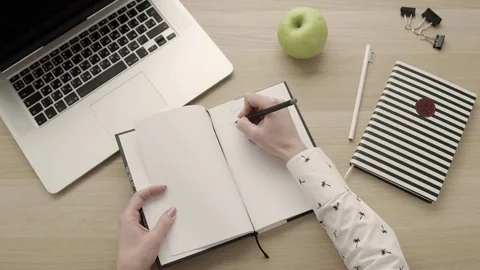 Writing down goals in notebook. Freelancer workspace. Productivity consept Stock Footage 83416829