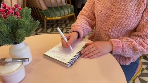 Writing down plans for the new year in a notebook. Stock Footage 258598924