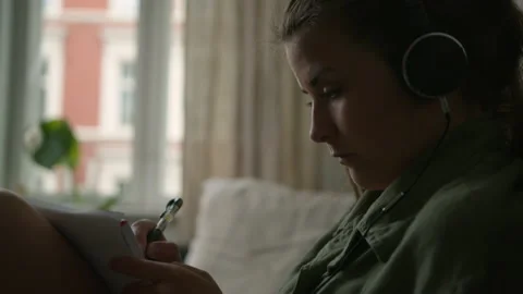 Writing down thoughts or brainstorming on pen and paper in her apartment home Stock Footage 133735052