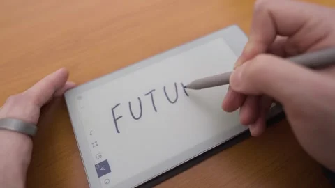 Writing on an e-ink tablet raises questions about the future. Asking important 스톡 동영상 330982375