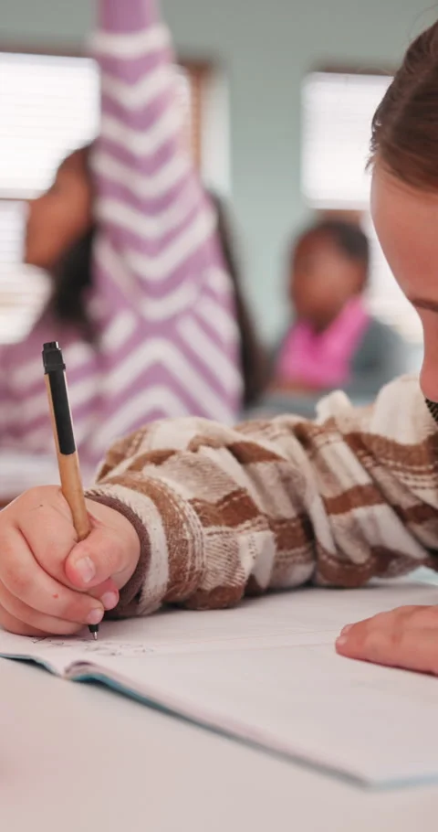 Writing, education and hands of child in classroom at high school for exam, test Stock Footage 341077919