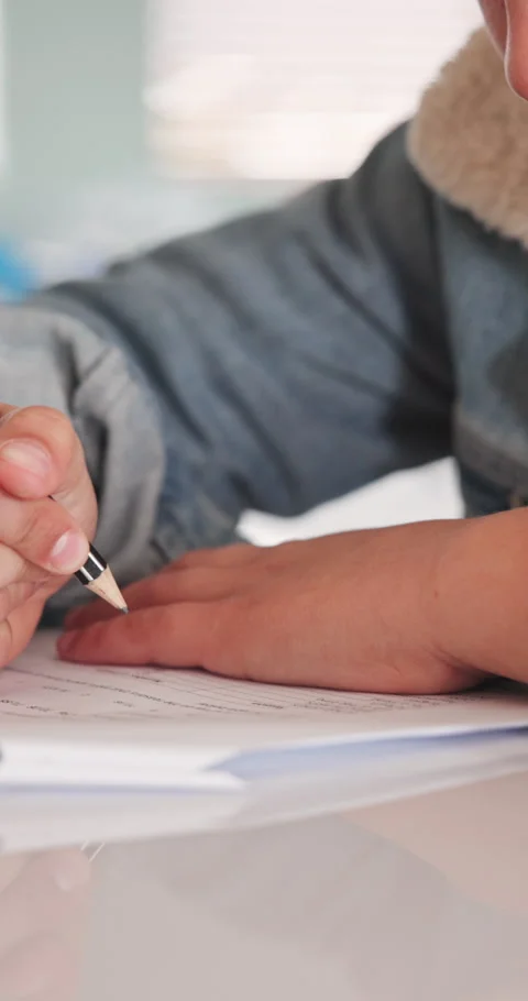 Writing, education and hands of kid in classroom at elementary school for exam Stock Footage 341078065