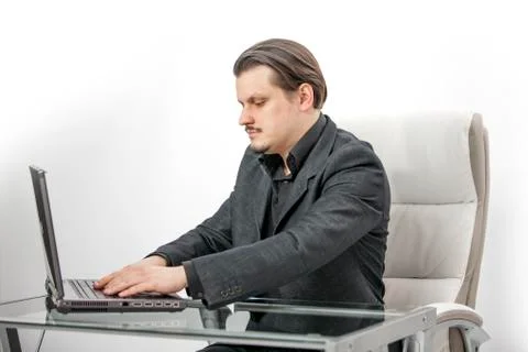 Writing an email on a computer on his desk. Foto stock