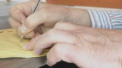Writing on an envelope at an office desk. Stock Footage 92364738