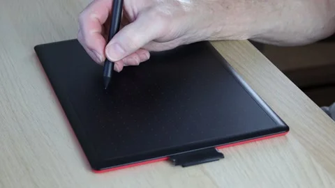 Writing on graphics tablet with digital pen. Senior man using technology Stock Footage 239408550