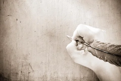 Writing hand with feather Stock Photos