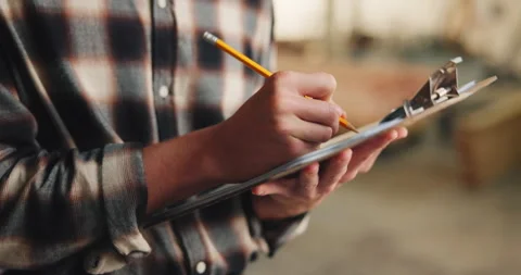 Writing, hands and man for carpentry with clipboard, inspection and material for Stock Footage 341303988