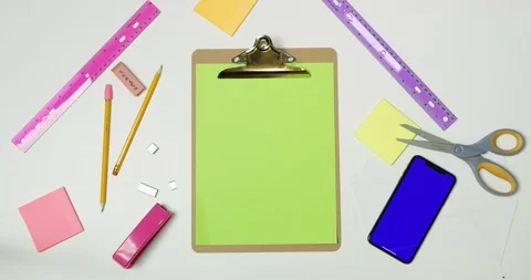 Writing Hello next to a green screen phone on a arts and crafts white table Stock Footage 97481875