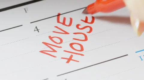 Writing house move date on calendar Stock Footage 33821282
