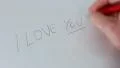 Writing "i love you" on a white foil HD Footage