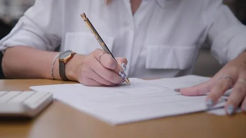 Writing Important Documents at a Desk Is Essential for Organizational Success Stock Photos