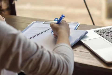 Writing important information from email to notebook Stock Photos