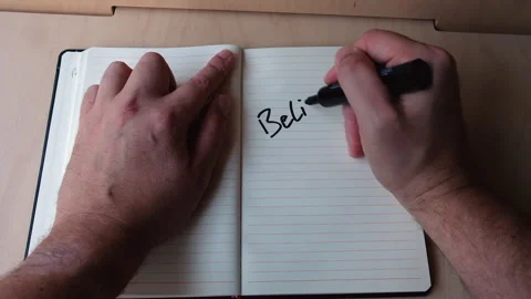 Writing in journal one word, Believe, in black permanent marker Stock Footage 306272806