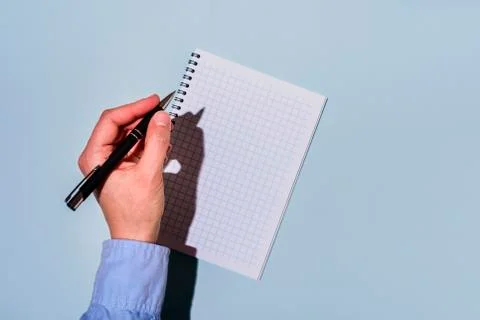 Writing by left hand in notepad Stock Photos