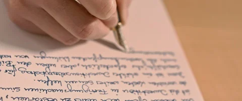 Writing a letter while camera is moving Stock Footage 120942842