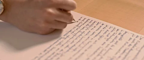 Writing a letter while camera is moving Stock Footage 120944951