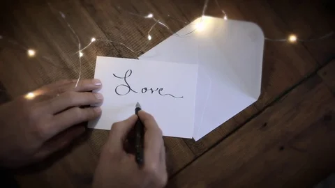 Writing "Love" in Calligraphy - Version 2 (Chestnut wood table) Stock Footage 83017540