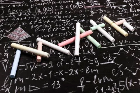 Writing math from chalk on background scientific formulas and calculations in Stock Photos