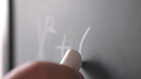 Writing a math formula with a chalk on a blackboard. Education, school, business 스톡 사진