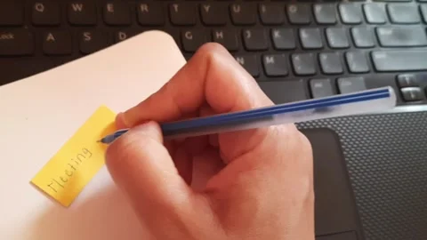 Writing Meeting Sticky Note and Placing It on Notebook Near Laptop Workspace 스톡 동영상 335452039