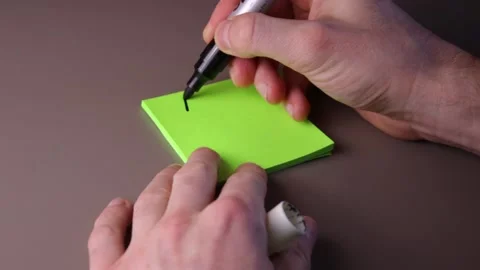 Writing memo on a post-it note Stock Footage 147137829