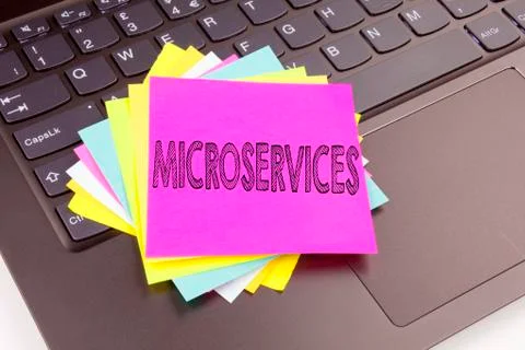 Writing Microservices text made in the office close-up on laptop computer key Stock Photos