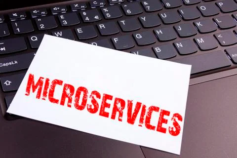Writing Microservices text made in the office close-up on laptop computer key Stock Photos