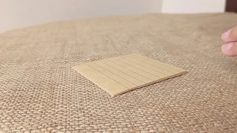 Writing a note with a black pen and brown paper Stock Footage 151027225