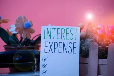 Writing note showing Interest Expense. Business photo showcasing cost of debt Fotos Stock