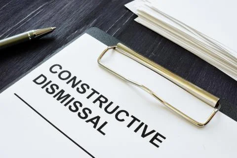 Writing note shows the text Constructive dismissal Stock Photos