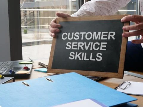 Writing note shows the text Customer Service Skills Stock Photos