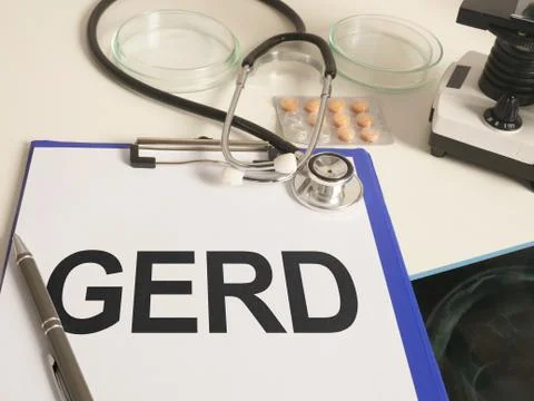 Writing note shows the text GERD gastroesophageal reflux disease, Stock Photos