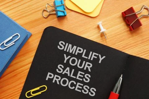 Writing note shows the text Simplify Your Sales Process Foto stock