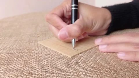 Writing a note for someone in the house Stock Footage 151027146