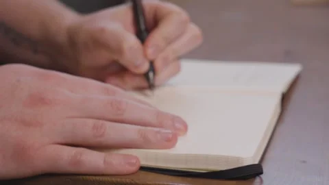Writing in a Notebook 4K Stock Footage 243396384