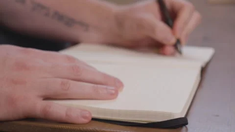 Writing in a Notebook 4K Stock Footage 243396494