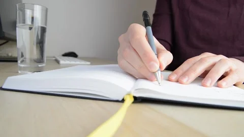 Writing in a notebook, close up Stock Footage 228479314