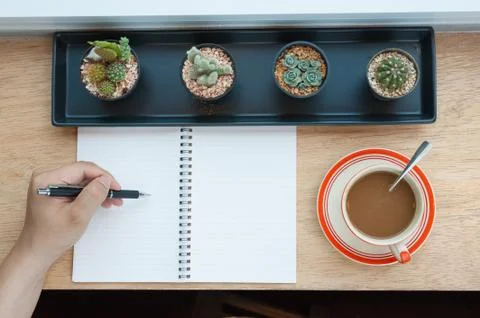 Writing on notebook with coffee cup Stock Photos