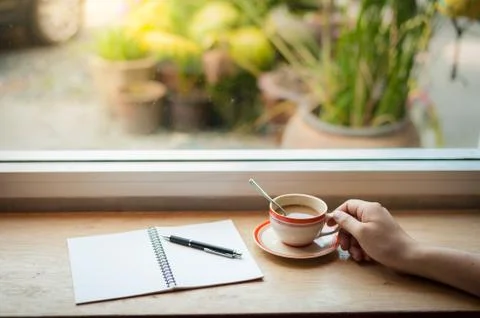 Writing on notebook with coffee cup Stock Photos