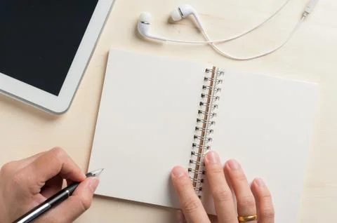 Writing on notebook with small tablet Stock Photos