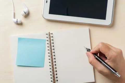 Writing on notebook with small tablet Foto stock