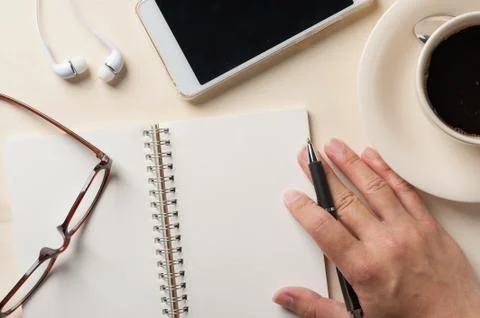 Writing on notebook with small tablet Stock Photos